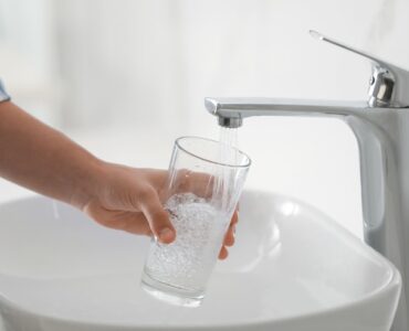 filling glass with bathroom sink water