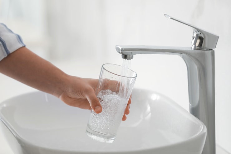 filling glass with bathroom sink water